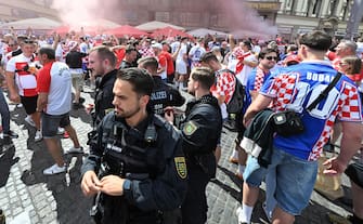 German Police officers chekc on Croatian supporters gathered in the central area of Leipzig, Germany, 24 June 2024. ANSA/DANIEL DAL ZENNARO
