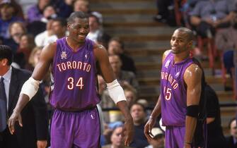 13 Nov 2001:  Hakeem Olijawon #34 of the Toronto Raptors celebrates with teammate Vince Carter #15 during the game against the Sacramento Kings at the Arco Arena in Sacramento, California.  The Kings defeated the Raptors 95-86.  NOTE TO USER: User expressly acknowledges and agrees that, by downloading and/or using this Photograph, User is consenting to the terms and conditions of the Getty Images License Agreement. Mandatory copyright notice: Copyright 2001 NBAE Mandatory Credit: Rocky Widner  /NBAE/Getty Images