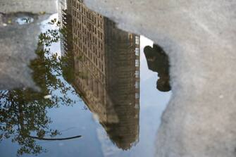The Flatiron building is reflected in a puddle in New York, U.S., on Wednesday, May 5, 2021. The century-old tower near the foot of Madison Square Park is empty, with all of its space available for the first time in more than 60 years, while it undergoes a total renovation of its interior. Photographer: Jeenah Moon/Bloomberg via Getty Images