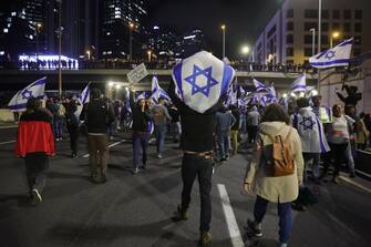 epa10530897 Protesters block the Ayalon main highway during a protest march against the government's justice system reform plans in Tel Aviv, Israel, 18 March 2023. Nationwide protests against the government's judicial reform plans are being held for eleven weeks in a row. Israel's parliament passed a draft law limiting the power of the Israeli Supreme Court in a first reading on 14 March.  EPA/ABIR SULTAN