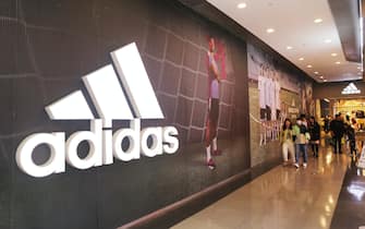 SHANGHAI, CHINA - OCTOBER 22, 2023 - Customers pass an Adidas advertisement featuring Lionel Messi at the Adidas flagship store in Shanghai, China, October 22, 2023. (Photo credit should read CFOTO/Future Publishing via Getty Images)