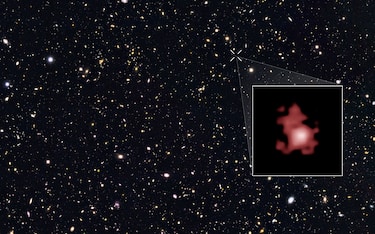 This image shows the position of the most distant galaxy discovered so far within a deep sky Hubble Space Telescope survey called GOODS North (Great Observatories Origins Deep Survey North). The survey field contains tens of thousands of galaxies stretching far back into time. The remote galaxy GN-z11, shown in the inset, existed only 400 million years after the Big Bang, when the Universe was only 3 percent of its current age. It belongs to the first generation of galaxies in the Universe and its discovery provides new insights into the very early Universe. This is the first time that the distance of an object so far away has been measured from its spectrum, which makes the measurement extremely reliable. GN-z11 is actually ablaze with bright, young, blue stars but these look red in this image because its light was stretched to longer, redder, wavelengths by the expansion of the Universe.