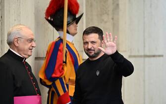 Ukrainian President Volodymyr Zelensky waves as he arrives, welcomed by Prefect of the Pontifical House, Monsignor Leonardo Sapienza (L), for a private audience with the Pope on May 13, 2023 in The Vatican. Ukrainian President Volodymyr Zelensky arrived in Rome on May 13 for meetings with President of Italy Sergio Mattarella, Prime Minister Giorgia Meloni and Pope Francis in his first visit to Italy since Russia's invasion. (Photo by Andreas SOLARO / AFP) (Photo by ANDREAS SOLARO/AFP via Getty Images)