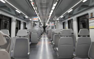 the inside of a renfe train wagon, empty at night.