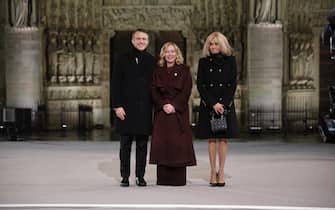 epa11762762 French President Emmanuel Macron (L) and his wife Brigitte (R) welcome Italian Prime Minister Giorgia Meloni (C) for the reopening ceremony of the Notre Dame de Paris Cathedral, in Paris, France, 07 December 2024. The Notre-Dame de Paris Cathedral reopens on 07 December after nearly six years of renovation work following its destruction by a fire on 15 April 2019.  EPA/CHRISTOPHE PETIT TESSON / POOL