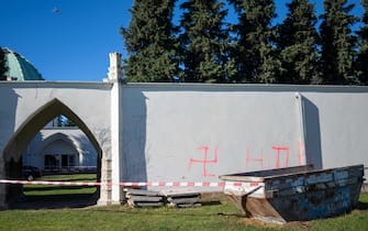 This photo taken on November 1, 2023 shows swastika symbols sprayed on an external wall in front of the ceremony hall at the Jewish part of the Central Cemetery in Vienna, Austria, after police cordoned off the area. Austrian police on November 1 were investigating a fire that damaged a hall at the Jewish part of the Vienna cemetery, with politicians condemning anti-Semitic violence. Cities in Europe have seen a spike in anti-Semitic attacks in response to the Israel-Hamas conflict. In the night from October 31 to November 1, a fire broke out at the Jewish part of the Vienna cemetery, damaging a ceremony hall, officers said. (Photo by GEORG HOCHMUTH / APA / AFP) / Austria OUT (Photo by GEORG HOCHMUTH/APA/AFP via Getty Images)