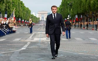 France's President Emmanuel Macron walks during the Bastille Day military parade on the Champs-Elysees avenue in Paris on July 14, 2023. (Photo by GONZALO FUENTES / POOL / AFP) (Photo by GONZALO FUENTES/POOL/AFP via Getty Images)