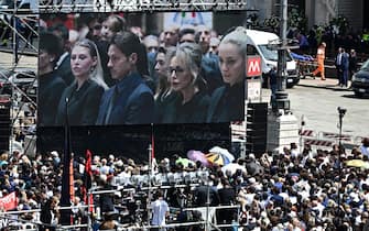 TOPSHOT - A view shows a screen displaying a live broadcast of Italian former Prime Minister, Silvio Berlusconi's daughter Barbara Berlusconi (L), son Pier Silvio Berlusconi, daughter Marina Berlusconi and partner of Silvio Berlusconi Marta Fascina inside the Duomo cathedral, at Piazza Duomo in Milan on June 14, 2023 for people to follow the state funeral for Italy's former prime minister and media mogul Silvio Berlusconi. (Photo by GABRIEL BOUYS / AFP) (Photo by GABRIEL BOUYS/AFP via Getty Images)