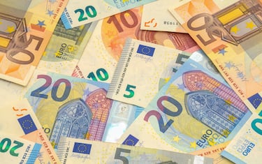 Scattered Pile of Euros with Various Bills.