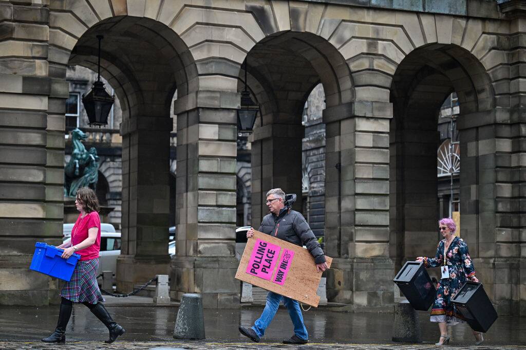 1316269691 EDINBURGH, SCOTLAND - MAY 04: Staff at Edinburgh City Council move ballot boxes as they're taken for distribution to polling stations on May 4, 2021 in Edinburgh, Scotland. Political party leaders have been out campaigning in the final two day before voters go to the polls open on Thursday in the Scottish Parliamentary election. (Photo by Jeff J Mitchell/Getty Images)