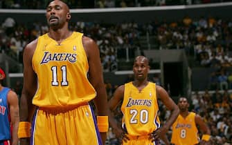LOS ANGELES - JUNE 8: Karl Malone #11, Gary Payton #20 and Kobe Bryant #8 of the Los Angeles Lakers looks on in Game two of the 2004 NBA Finals against the Detroit Pistons   June 8, 2004 at Staples Center in Los Angeles, California.  NOTE TO USER: User expressly acknowledges and agrees that, by downloading and or using this photograph, User is consenting to the terms and conditions of the Getty Images License Agreement.  Mandatory Copyright Notice: Copyright 2004 NBAE  (Photo by Jesse D. Garrabrant/NBAE via Getty Images)