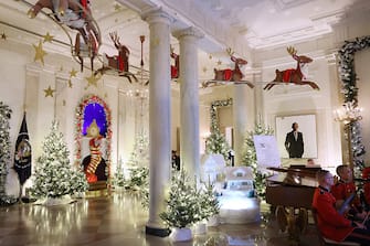WASHINGTON, DC - NOVEMBER 27: Decorations of Santa Claus in his sleigh and a team of reindeer fly through the columns of the Entrance Hall during a media preview of the 2023 holiday decorations at the White House November 27, 2023 in Washington, DC. The theme for this year's White House decorations is â  Magic, Wonder and Joy,â   and is designed to capture the â  delight and imagination of childhood.â   The White House expects to welcome approximately 100,000 visitors during the holiday season. (Photo by Kevin Dietsch/Getty Images)