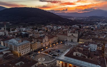 An aerial drone view shows sunset above Piazza Duomo square in LAquila, Abruzzo, Italy, on March 31, 2023. On april 6 will occur 14th anniversary of 2009 huge earthquake in LAquila.  (Photo by Lorenzo Di Cola/NurPhoto via Getty Images)