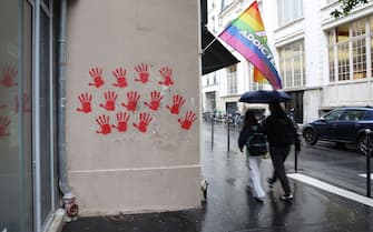 A picture shows red hand graffitis painted on buildings' walls of the Moussy street, in the area where earlier the Holocaust memorial was vandalized with the same red hand prints in Paris, on May 14, 2024. A French Jewish organisation on May 14 condemned a "hateful rallying cry against Jews" and Paris authorities filed a criminal complaint after red hand graffiti was painted onto France's Holocaust Memorial. (Photo by Antonin UTZ / AFP) (Photo by ANTONIN UTZ/AFP via Getty Images)