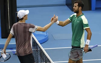 epa11093401 Jannik Sinner (L) of Italy greets Karen Khachanov (R) of Russia at the conclusion of their Men's 4th round match at the Australian Open tennis tournament in Melbourne, Australia, 21 January 2024.  EPA/MAST IRHAM