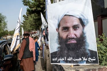 A poster of Taliban Supreme Leader Hibatullah Akhundzada is seen along a road in Kabul on August 14, 2023. (Photo by Wakil KOHSAR / AFP) (Photo by WAKIL KOHSAR/AFP via Getty Images)