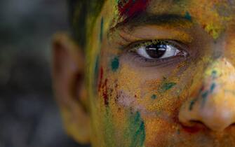 epa08280075 A young man is covered in colored powder during Holi Festival celebrations in Kathmandu, Nepal, 09 March 2020. Holi, also known as the Festival of Colors, marks the beginning of spring and is celebrated all over Nepal and neighboring India.  EPA/NARENDRA SHRESTHA