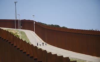 TIJUANA, MEXICO - MAY 11: Migrants are stuck between the Tijuana-San Diego border for the past week, hoping to enter the United States, after Title 42 expires in Tijuana, Mexico on May 11, 2023. (Photo by Carlos Moreno/Anadolu Agency via Getty Images)