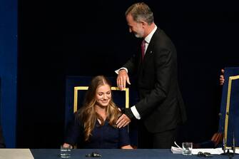 (FILES) Spanish Crown Princess of Asturias Leonor (L) and Spain's King Felipe VI preside the 2023 Princess of Asturias award ceremony at the Campoamor theatre in Oviedo on October 20, 2023. Princess Leonor, the heiress to the Spanish crown, will swear loyalty to the constitution on October 31 on her 18th birthday, helping to turn the page on the scandal-tainted reign of her grandfather, Juan Carlos. After taking the oath Princess Leonor can legally succeed her father, King Felipe VI, and automatically becomes head of state in the event of the monarch's absence. (Photo by MIGUEL RIOPA / AFP)