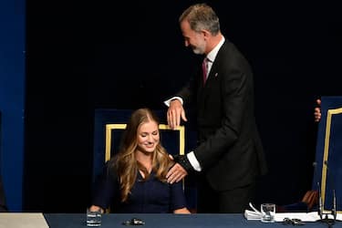 (FILES) Spanish Crown Princess of Asturias Leonor (L) and Spain's King Felipe VI preside the 2023 Princess of Asturias award ceremony at the Campoamor theatre in Oviedo on October 20, 2023. Princess Leonor, the heiress to the Spanish crown, will swear loyalty to the constitution on October 31 on her 18th birthday, helping to turn the page on the scandal-tainted reign of her grandfather, Juan Carlos. After taking the oath Princess Leonor can legally succeed her father, King Felipe VI, and automatically becomes head of state in the event of the monarch's absence. (Photo by MIGUEL RIOPA / AFP)
