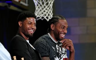 LOS ANGELES, CA - JULY 24: Kawhi Leonard (R) and Paul George laugh as they listen to Los Angeles Clippers owner Steve Ballmer speak (not in frame) during their introductory news conference at Green Meadows Recreation Center on July 24, 2019 in Los Angeles, California. NOTE TO USER: User expressly acknowledges and agrees that, by downloading and or using this photograph, User is consenting to the terms and conditions of the Getty Images License Agreement. at Green Meadows Recreation Center on July 24, 2019 in Los Angeles, California. (Photo by Kevork Djansezian/Getty Images)