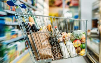 shopping cart with purchases in supermarket