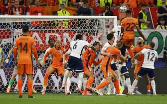 Netherlands' defender #22 Denzel Dumfries (Top R) heads the ball during the UEFA Euro 2024 semi-final football match between the Netherlands and England at the BVB Stadion in Dortmund on July 10, 2024. (Photo by Odd ANDERSEN / AFP) (Photo by ODD ANDERSEN/AFP via Getty Images)