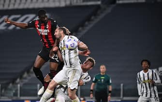 AC Milan's English defender Fikayo Tomori (Top L) scores a header during the Italian Serie A football match Juventus vs AC Milan on May 09, 2021 at the Juventus stadium in Turin. (Photo by Marco BERTORELLO / AFP) (Photo by MARCO BERTORELLO/AFP via Getty Images)