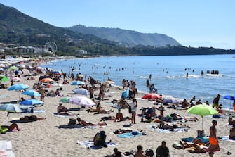 PALERMO, SICILY, ITALY - JUNE 6: A view of the beach in the town of Cefalu, located 75 kilometers east of Palermo, which remains one of the top tourist destinations in Sicily, Italy, on June 6, 2024. Cefalu, with its extensive coastline, sandy and rocky beaches, small fish restaurants, narrow streets and alleys, and the Duomo Basilica featuring Arab architecture, stands out as a must-visit destination for many tourists. Despite being the beginning of the summer season, an increase in tourist activity has already been observed in Cefalu. (Photo by Baris Seckin/Anadolu via Getty Images)