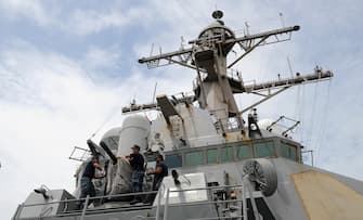 US Navy officers remove the cover of the Phalanx Close-In Weapon System (CIWS) of the USS Milius DDG69, a multi-mission capable guided missile destroyer ship docked at the Manila south harbour on August 18, 2012. The USS Milius is in Manila for a four-day goodwill visit. AFP PHOTO / NOEL CELIS        (Photo credit should read NOEL CELIS/AFP/GettyImages)