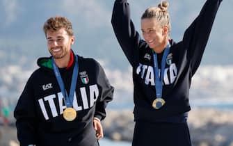 epa11537102 Gold medalists Ruggero Tita and Caterina Banti of Italy during the medal ceremony for the Mixed Multihull event of the Sailing competitions in the Paris 2024 Olympic Games, at the Marseille Marina in Marseille, France, 08 August 2024.  EPA/SEBASTIEN NOGIER