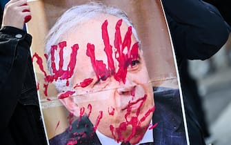 Protestors stain a picture of Italian minister of the interior Matteo Piantedosi during a rally held next to town harbour to contest ministers Matteo Piantedosi and Matteo Salvini after Pisa clashes in Genoa, Italy, 4 March 2024. ANSA/SIMONE ARVEDA