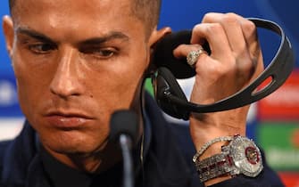 Juventus' Portuguese striker Cristiano Ronaldo listens to his headphones during a press conference at Old Trafford in Manchester, north west England on October 22, 2018, ahead of their UEFA Champions League group H football match against Juventus on October 23. (Photo by Oli SCARFF / AFP) (Photo by OLI SCARFF/AFP via Getty Images)