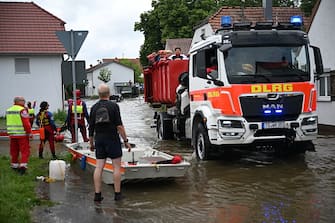 A vehicle by the German Life Saving Association (DLRG) makes its way on a flooded street in Baar-Ebenhausen on June 2, 2024. . Heavy rains from May 31, 2024 onwards have led to flooding across the southern German states of Baden-Wuerttemberg and Bavaria. (Photo by LUKAS BARTH / AFP) (Photo by LUKAS BARTH/AFP via Getty Images)