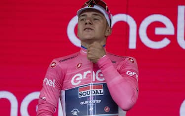 Belgian rider Remco Evenepoel of team Soudal Quick-Step celebrates on the podium retaining wearing the overall leader's pink jersey after winning the  third stage of the 2023 Giro d'Italia cycling race over 213 km from Vasto to Melfi, Italy, 08 May 2023. ANSA/LUCA ZENNARO