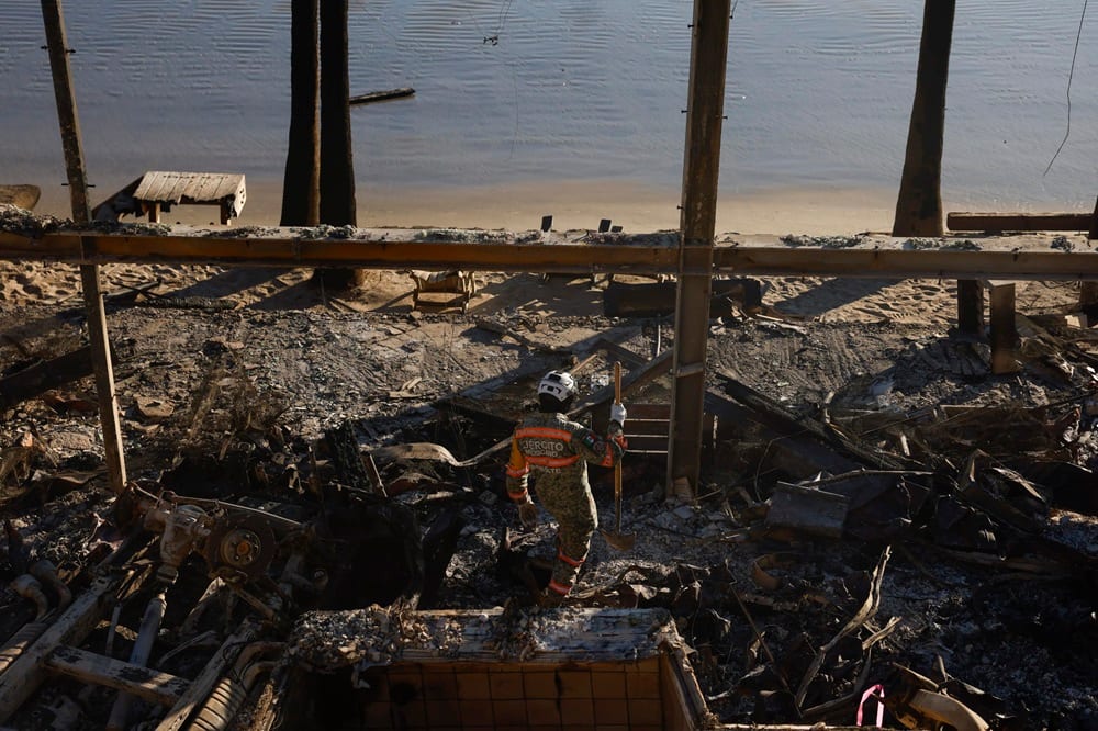 epa11825199 Mexican Urban Search and Rescue search the remains of a home in Malibu, California, USA, 14 January 2025. Much of Southern California is under an elevated fire risk, as the Santa Ana winds have returned and are predicted to affect the area until Wednesday evening according to the National Weather Service. The LA County Medical Examiner's Office has stated that the suspected death toll from the Los Angeles fires now stands at 25, as search and rescue teams, both local and abroad, search the affected fire areas.  EPA/CAROLINE BREHMAN