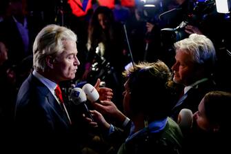 epa10990085 PVV leader Geert Wilders (L) talks to media as he responds to the results of the House of Representatives elections in Scheveningen, Netherlands, 22 November 2023. Dutch voters headed to the polls on 22 November to elect the members of the House of Representatives and a new prime minister, after Netherlands' longest-serving prime minister, Mark Rutte's cabinet collapsed in July.  EPA/REMKO DE WAAL