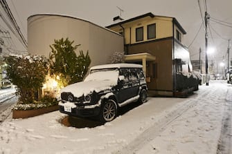TOKYO, JAPAN - FEBRUARY 05: A general view of a snow covered car and residential area during the first snowfall of the year in Tokyo, Japan on February 05, 2024. (Photo by David Mareuil/Anadolu via Getty Images)