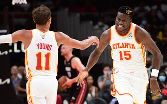 ATLANTA, GA - OCTOBER 14: Clint Capela #15 and Trae Young #11 of the Atlanta Hawks celebrate during a preseason game against the Miami Heat on October 14, 2021 at State Farm Arena in Atlanta, Georgia.  NOTE TO USER: User expressly acknowledges and agrees that, by downloading and/or using this Photograph, user is consenting to the terms and conditions of the Getty Images License Agreement. Mandatory Copyright Notice: Copyright 2021 NBAE (Photo by Adam Hagy/NBAE via Getty Images)