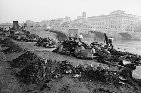 (Original Caption) 11/17/1966-Florence, Italy- Flood-borne debris is heaped in neat piles on the banks of the River Arno as cleanup operations go on following severe floods that struck this and other Italian cities. The flood claimed scores of lives and wrought irreplacable damage to many of the nation's art treasures.