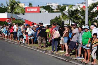 People queue to enter a supermarket to purchase groceries and food in the Magenta district of Noumea, France's Pacific territory of New Caledonia, on May 18, 2024. Anger over France's plan to impose new voting rules has spiralled into the deadliest violence in four decades in the archipelago of 270,000 people, which lies between Australia and Fiji -- 17,000 kilometres (10,600 miles) from Paris. (Photo by Theo Rouby / AFP) (Photo by THEO ROUBY/AFP via Getty Images)