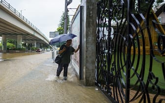 A resident wades through floodwaters during heavy rain in Hong Kong, China, on Sept. 8, 2023. Hong Kong's heaviest rainstorm since records began in 1884 flooded the financial hub's streets and sent torrents of water rushing through subway stations, bringing much of the city to a standstill and forcing the stock market to scrap trading on Friday. Photographer: Justin Chin/Bloomberg via Getty Images
