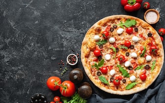 Italian Pizza On Black Concrete Background. Copy Space For Text. Tasty Pizza