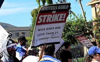 BURBANK, CALIFORNIA - AUGUST 02: Members of SAG-AFTRA and WGA walk the picket line at The Walt Disney Studios on August 02, 2023 in Burbank, California. Members of SAG-AFTRA and WGA (Writers Guild of America) have both walked out in their first joint strike against the studios since 1960. The strike has shut down a majority of Hollywood productions with writers approaching the third month of their strike against the Hollywood studios. (Photo by Albert L. Ortega/Getty Images)