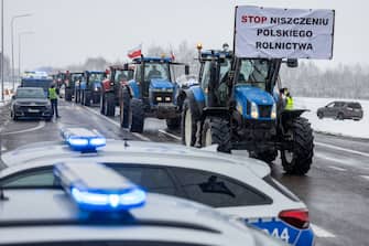 A banner reading "Stop destroying the Polish agriculture" is seen on February 9, 2024 as farmers with tractors block the access to the Polish-Ukrainian border crossing in Dorohusk, eastern Poland, during a farmers' protest across the country against EU politics and Ukrainian agricultural products allowed on EU market at low prices. (Photo by Wojtek Radwanski / AFP) (Photo by WOJTEK RADWANSKI/AFP via Getty Images)