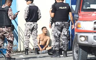 GUAYAQUIL, ECUADOR - APRIL 14: A inmate is kept arrested by guards after a riot on April 14, 2023 in Guayaquil, Ecuador. Authorities report at least 3 injured inmates after a fight inside the 'Centro de Rehabilitacion Social de Varones N. 1' de Guayaquil known as the 'Del Litoral Prison'. Official reports mention that the situation has been controlled. (Photo by Gerardo Menoscal/Agencia Press South/Getty Images)