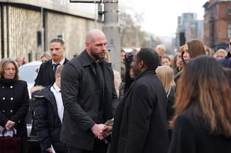 The father of Indi Gregory, Dean Gregory (centre) speaks with mourners outside St Barnabus Cathedral, Nottingham, following her funeral service. The baby girl died shortly after her life-support treatment was withdrawn after her parents, Mr Gregory and Claire Staniforth who are both in their 30s and from Ilkeston, Derbyshire, lost legal bids in the High Court and Court of Appeal in London for specialists to keep treating her. Picture date: Friday December 1, 2023.
