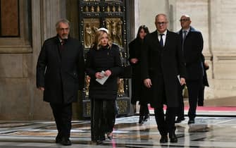 Italy's Prime Minister, Giorgia Meloni and Rome's Mayor Roberto Gualtieri pass the Holy Door of St Peter's Basilica in the Vatican during a ceremony to mark the start of the Catholic Jubilee Year, on December 24, 2024. Pope Francis marks Christmas Eve with a special ceremony launching Jubilee 2025, a year of Catholic celebrations set to draw more than 30 million pilgrims to Rome. Over the next 12 months, pilgrims will pass through the large and imposing bronze door, which is normally closed, by tradition benefiting from a "plenary indulgence", a type of forgiveness for their sins. (Photo by Alberto PIZZOLI / POOL / AFP)