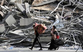 epa10918372 Residents of Gaza City have a few belongings gathered as they begin to evacuate following an Israeli warning of increased military operations in the Gaza strip, 14 October 2023. The Israeli Defense Force (IDF) on 13 October had called for the evacuation of all civilians of northern Gaza ahead of an expected ground invasion.  EPA/HAITHAM IMAD