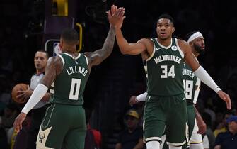 LOS ANGELES, CA - OCTOBER 15: Damian Lillard #0 high fives Giannis Antetokounmpo #34 of the Milwaukee Bucks during the preseason game on October 15, 2023 at Crypto.Com Arena in Los Angeles, California. NOTE TO USER: User expressly acknowledges and agrees that, by downloading and/or using this Photograph, user is consenting to the terms and conditions of the Getty Images License Agreement. Mandatory Copyright Notice: Copyright 2023 NBAE (Photo by Juan Ocampo/NBAE via Getty Images)